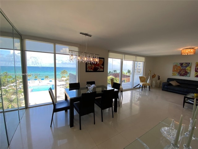 dining room with floor to ceiling windows, a water view, and light tile patterned flooring