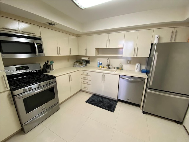 kitchen with stainless steel appliances, sink, and light tile patterned floors