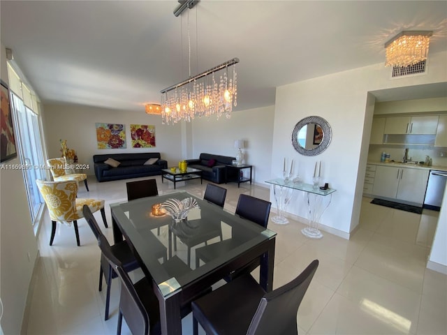 tiled dining area with an inviting chandelier and sink