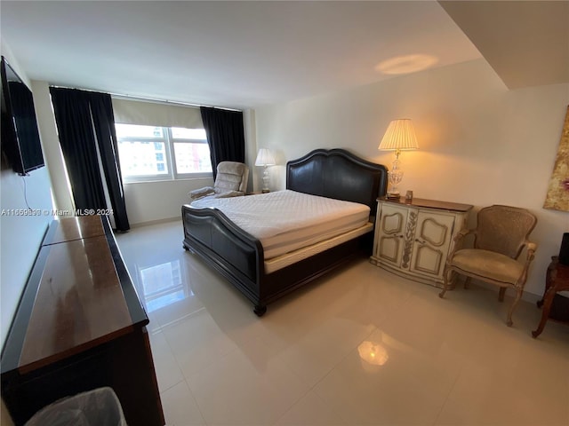 bedroom with light tile patterned floors