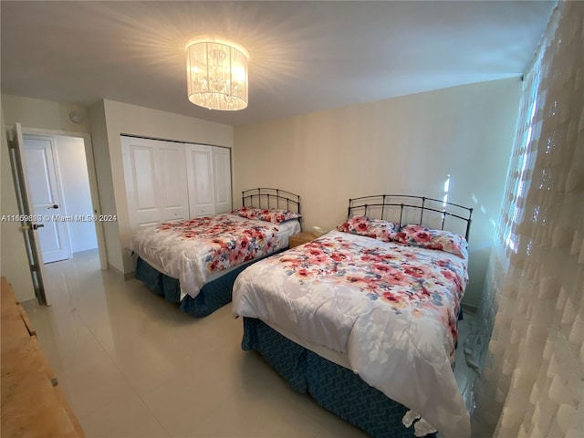 bedroom with a closet and a notable chandelier