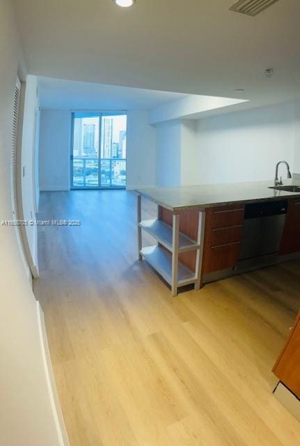 kitchen with black dishwasher, light hardwood / wood-style floors, dark brown cabinetry, and sink