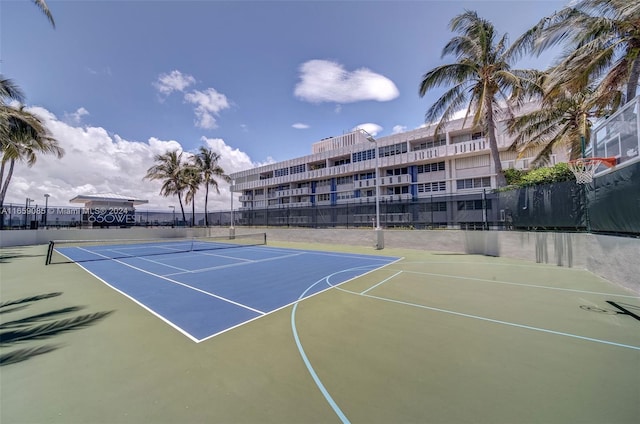 view of tennis court with basketball hoop