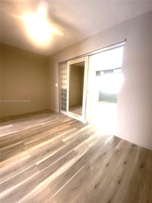 empty room featuring wood-type flooring, a closet, and ceiling fan