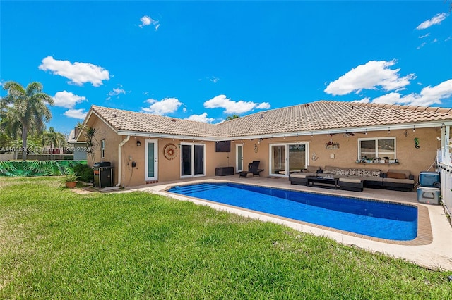 view of swimming pool featuring an outdoor hangout area, a lawn, and a patio