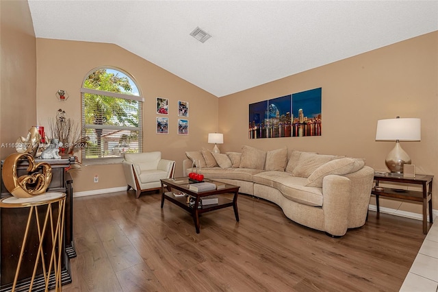 living room with vaulted ceiling and wood-type flooring