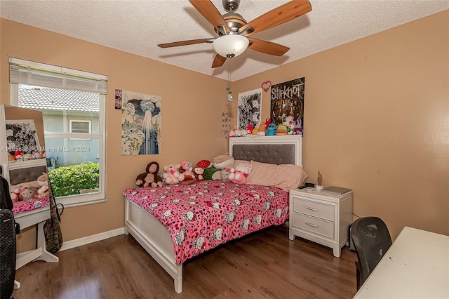 bedroom featuring ceiling fan, dark hardwood / wood-style floors, and a textured ceiling