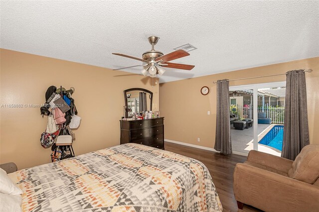 bedroom featuring dark hardwood / wood-style flooring, access to exterior, ceiling fan, and a textured ceiling