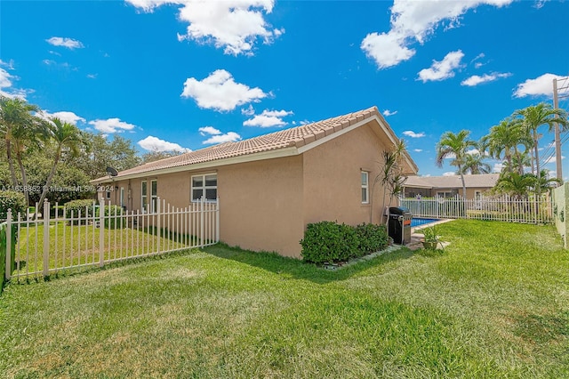 view of side of property with a yard