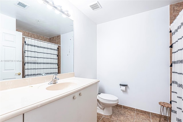 bathroom with walk in shower, vanity, and toilet