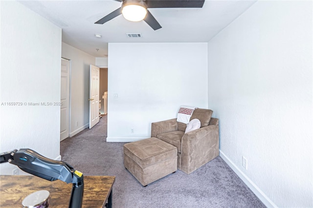 sitting room with ceiling fan and carpet flooring