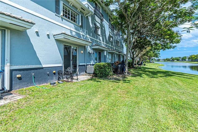 view of yard featuring a water view and cooling unit