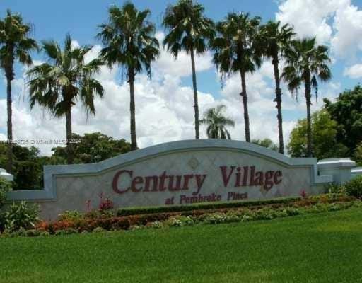 community sign featuring a lawn