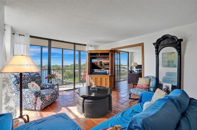 2500 NE 135th St Unit C301, North Miami, FL 33181 - tiled living room with plenty of natural light, a textured ceiling, and a wall of windows