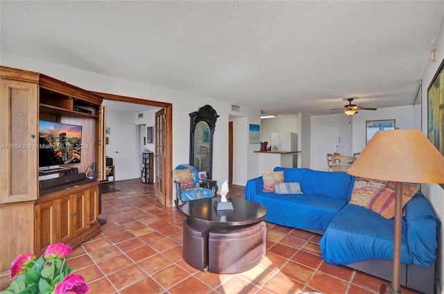 2500 NE 135th St Unit C301, North Miami, FL 33181 - tiled living room with a ceiling fan and a textured ceiling