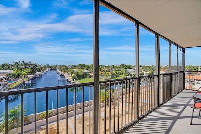 sunroom / solarium with a water view