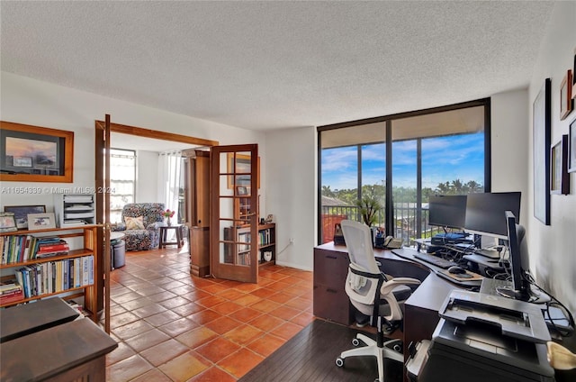 home office featuring a textured ceiling and light tile patterned flooring