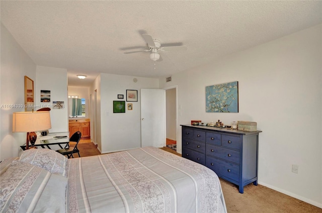 2500 NE 135th St Unit C301, North Miami, FL 33181 - bedroom with light colored carpet, a textured ceiling, a ceiling fan, ensuite bathroom, and baseboards