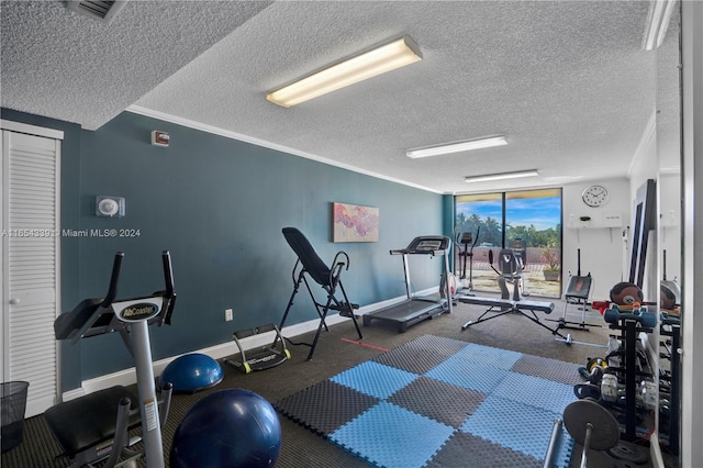 gym with a wall of windows, ornamental molding, and a textured ceiling