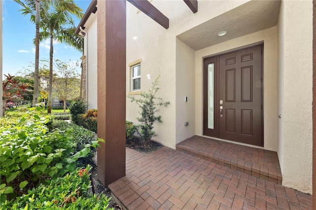 view of exterior entry featuring stucco siding