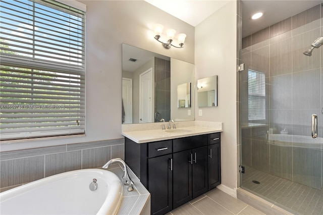 full bath featuring a tub to relax in, visible vents, a shower stall, vanity, and tile patterned floors