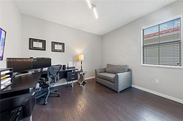 office area with dark wood-style flooring and baseboards