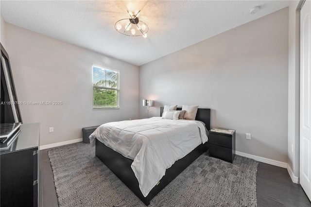 bedroom featuring baseboards and a textured ceiling