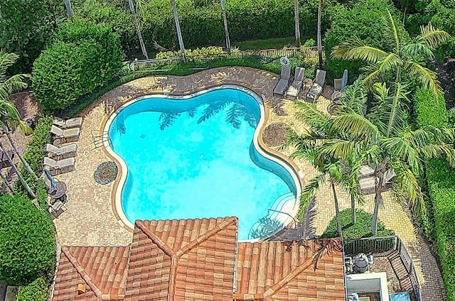 pool with a patio and a fenced backyard