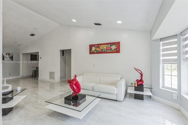 living room with high vaulted ceiling