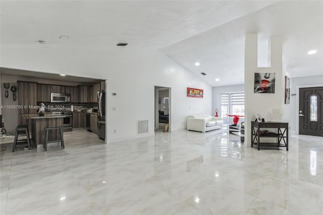 living room featuring high vaulted ceiling