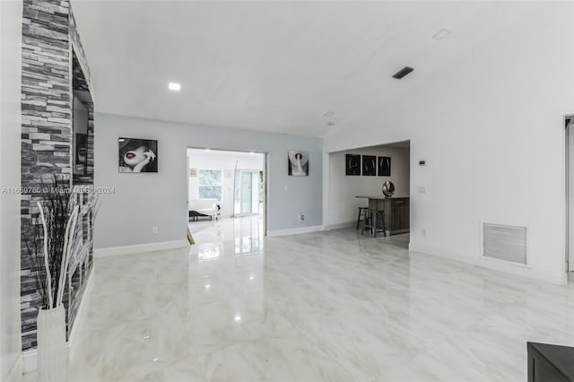 unfurnished room with lofted ceiling