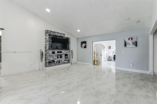 unfurnished living room featuring a fireplace and vaulted ceiling