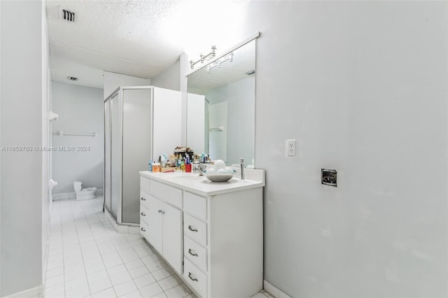 bathroom featuring toilet, an enclosed shower, tile patterned flooring, vanity, and a textured ceiling