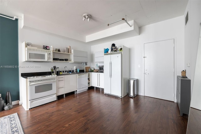 kitchen with white appliances, dark hardwood / wood-style flooring, and sink