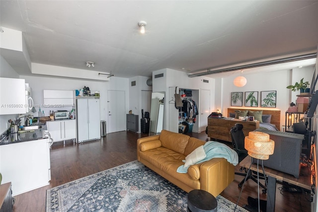 living room with dark hardwood / wood-style flooring