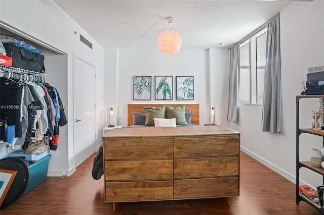 bedroom featuring a closet and dark hardwood / wood-style floors