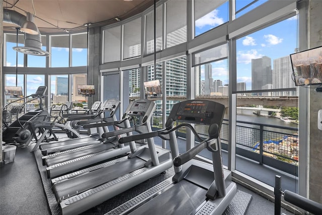 exercise room with a water view