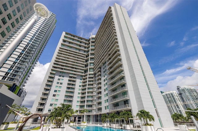 view of building exterior featuring a community pool