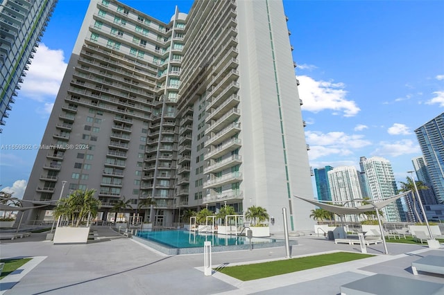 view of building exterior featuring a community pool