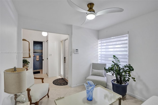 sitting room with ceiling fan and light tile patterned floors