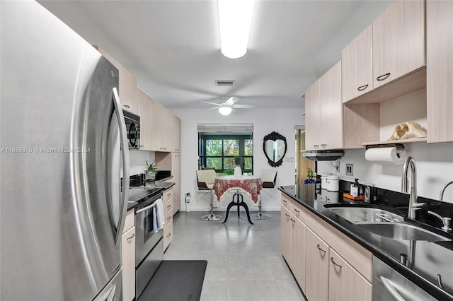 kitchen featuring appliances with stainless steel finishes, ceiling fan, light brown cabinetry, and sink