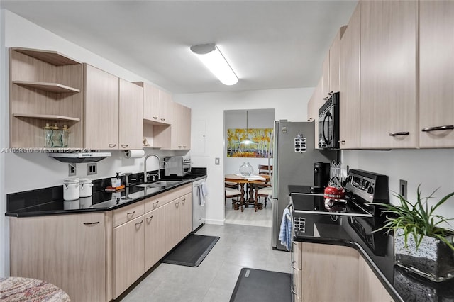 kitchen with dark stone counters, dishwasher, light brown cabinetry, sink, and electric range