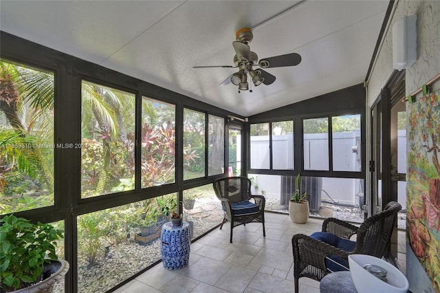 sunroom / solarium with ceiling fan and vaulted ceiling