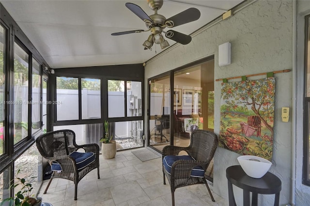 sunroom with ceiling fan and vaulted ceiling