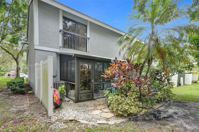 rear view of property featuring a sunroom