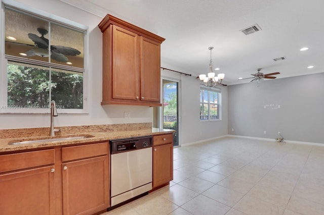 kitchen featuring ceiling fan with notable chandelier, stainless steel dishwasher, sink, and light stone counters