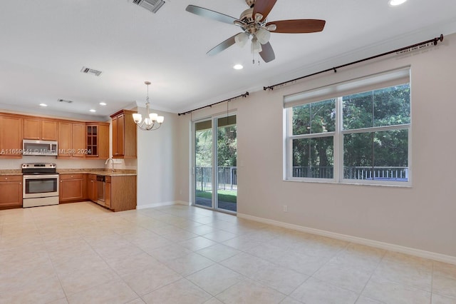 kitchen with hanging light fixtures, ceiling fan with notable chandelier, light tile patterned floors, stainless steel appliances, and crown molding