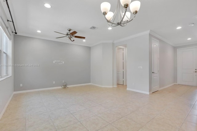 spare room featuring ceiling fan with notable chandelier and crown molding