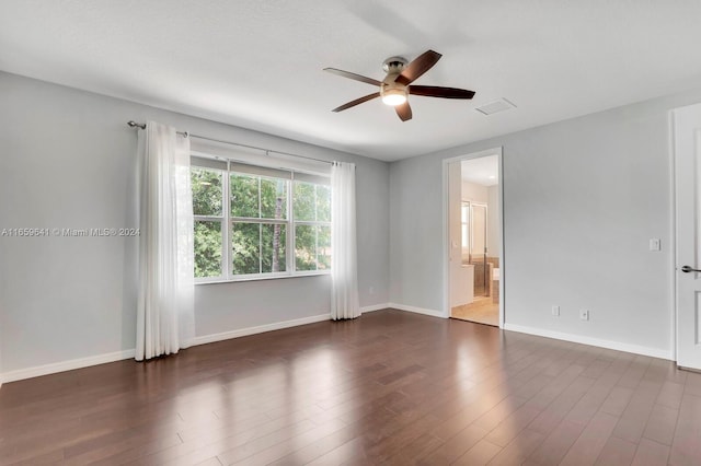 unfurnished room featuring ceiling fan and dark wood-type flooring