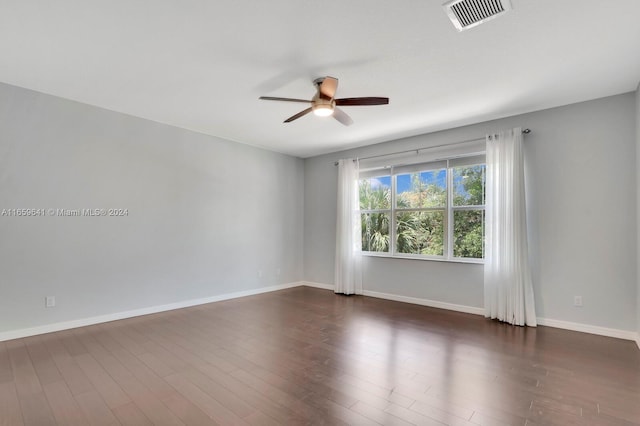 empty room featuring ceiling fan and dark hardwood / wood-style floors